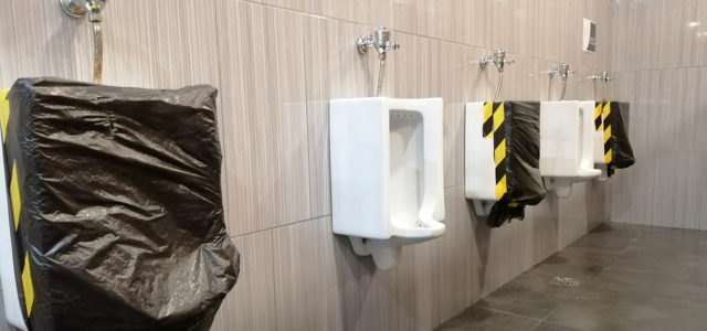 Public Men's Urinals Covered for Social Distancing