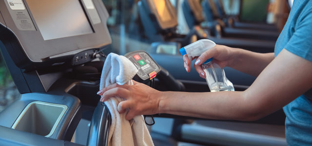 Sanitizing Treadmill at Gym