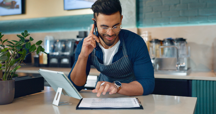 Barista, phone call or documents for restaurant, cafe logistics or coffee shop management. Supply chain checklist, manager or man in mobile communication for stock inventory in startup with paperwork
