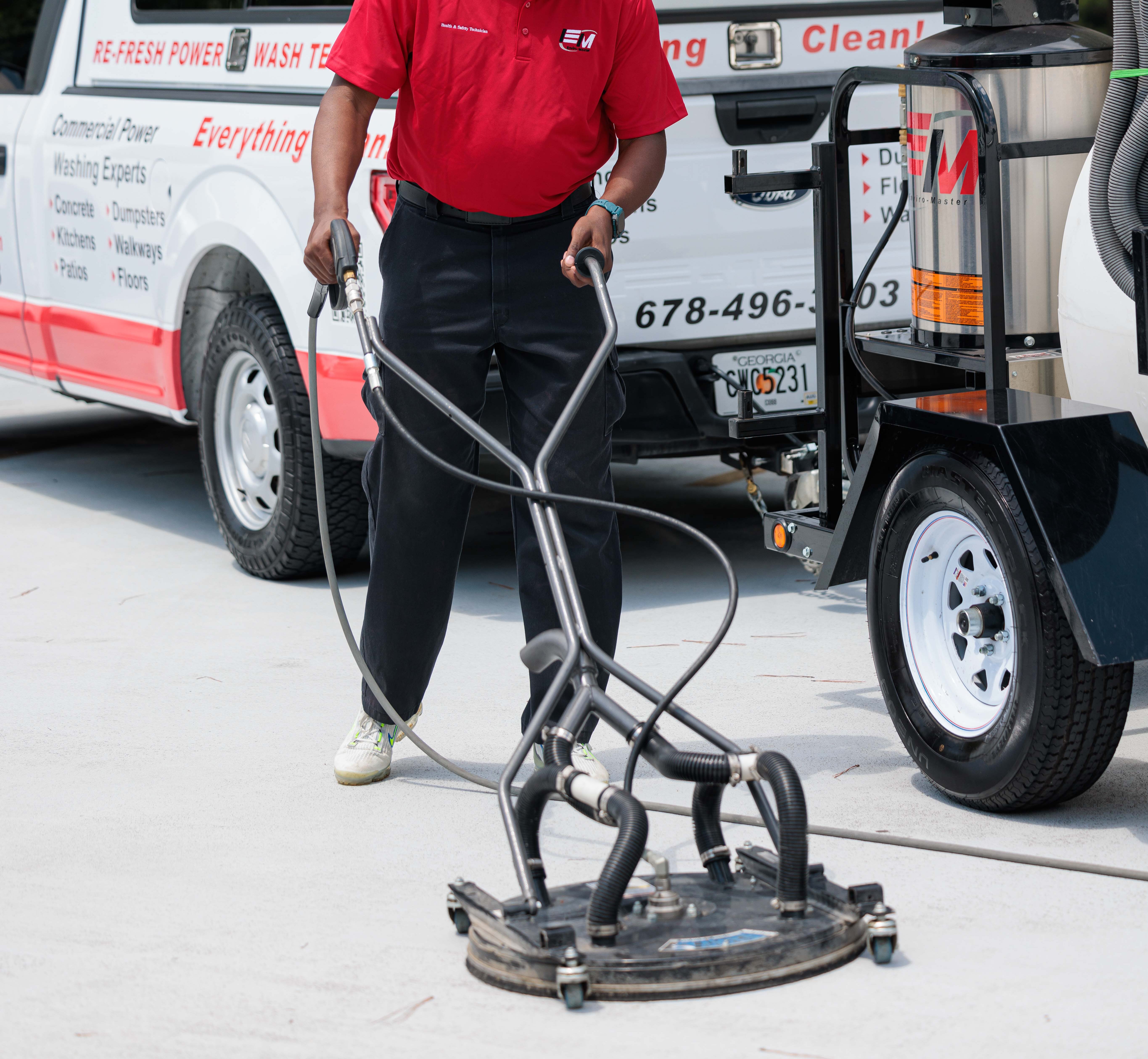 employee with pressure washer