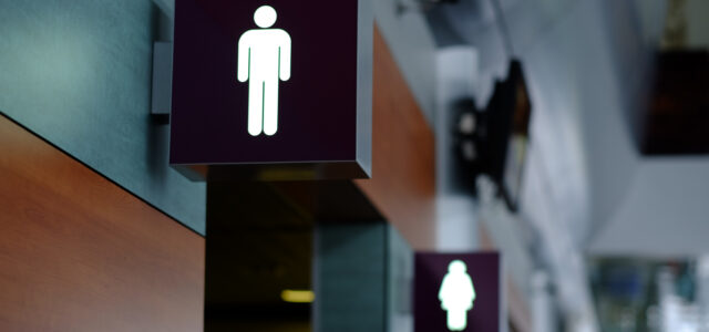 entrance to the male and female toilet. Sign in airport.