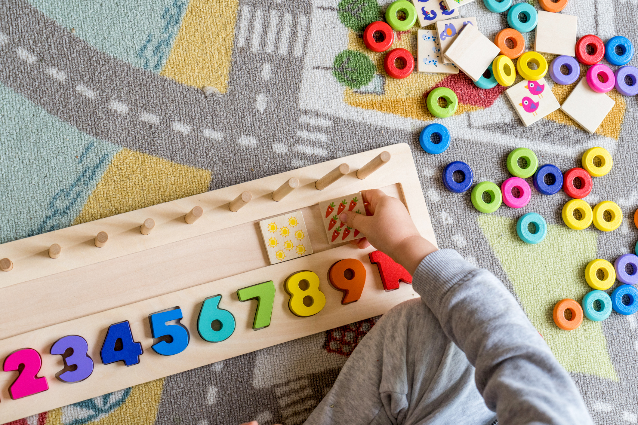 Baby toddler early development. Wooden stack and count rainbow colored learning game. Child learn colors and numbers