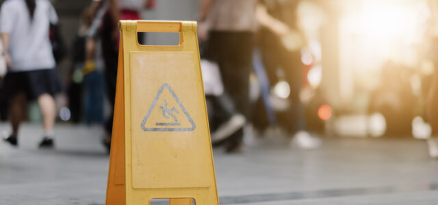 Sign showing warning of caution wet floor whitin airport.