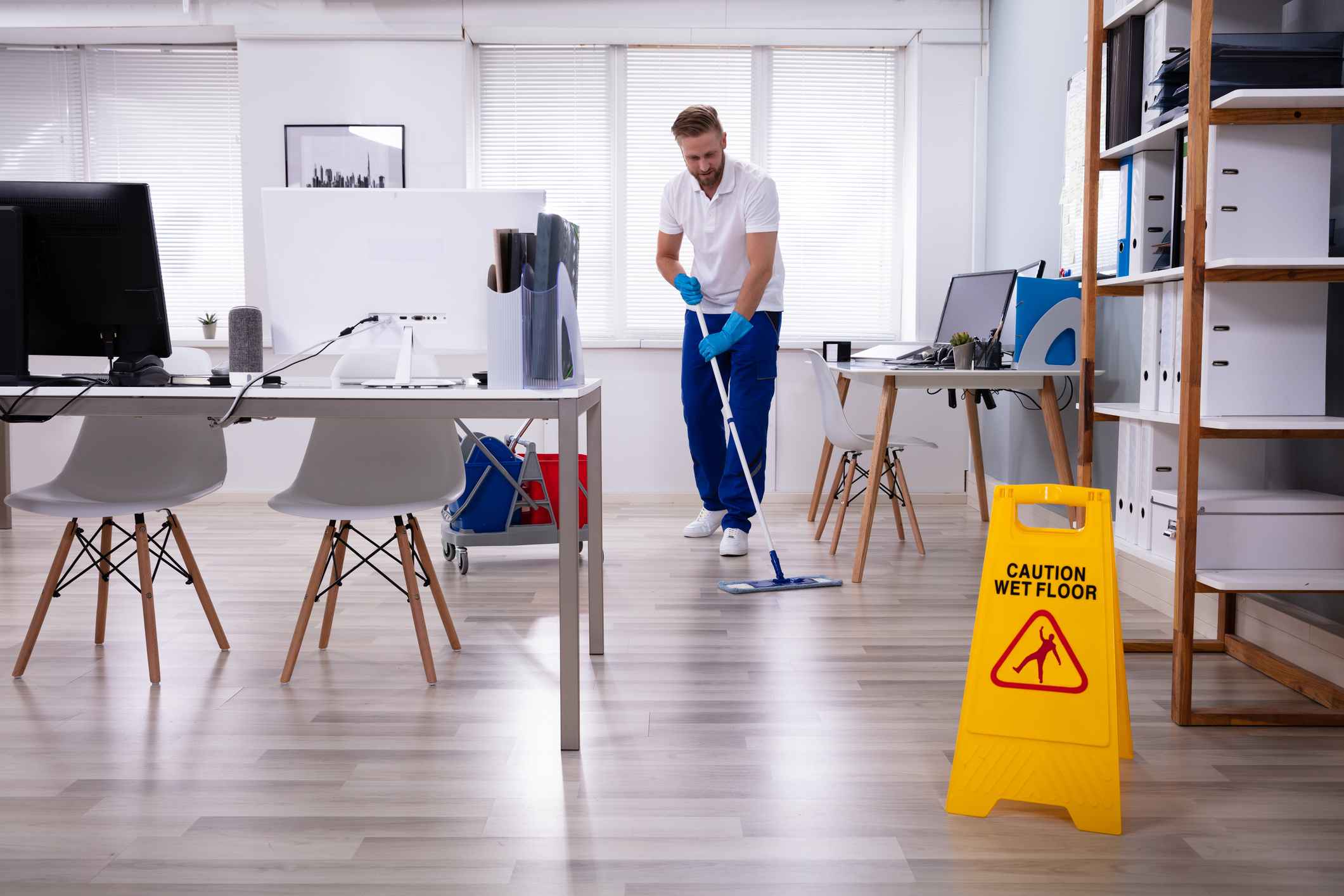 Janitor With Mop Cleaning Office