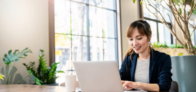 Portrait smile beautiful business asian woman in pink suit working in office desk virtual computer. Small business owner people employee freelance online sme marketing e-commerce telemarketing concept