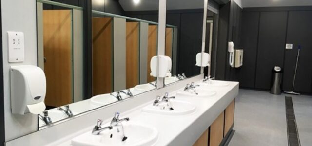 5 Steps to Take When Your Restroom Has Stained Mirrors A row of clean sinks in a public bathroom.